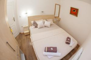 a small bedroom with a large bed in a room at Apartments Old Town in Budva