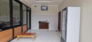a hallway with a bench and a table in a room at Hotel O Madina Homestay in Samarinda +17 photos