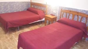 A bed or beds in a room at Pensión Campoy