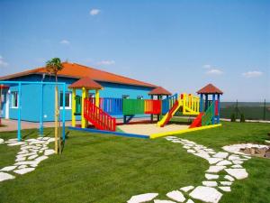 a playground with colorful equipment in a park at HollidayVillage 5B in Matka Božia