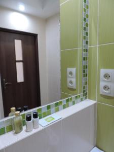 a bathroom with a large mirror and a sink at Apartament Green in Krosno