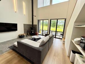 a living room with a couch and a table at Kinagashi Happo Chalet West in Hakuba