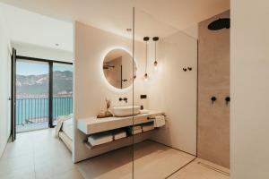 a bathroom with a sink and a mirror at LUXE VISTA Lakeside Villa Brenzone in Brenzone sul Garda
