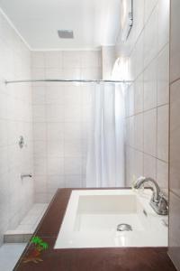 a bathroom with a sink and a shower at Jaynet Oceanview Resort in Boljoon