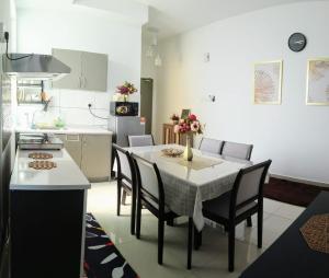 a kitchen and dining room with a table and chairs at BangiSky Homestay, Quite, Strategic & Convinient in Bandar Baru Bangi