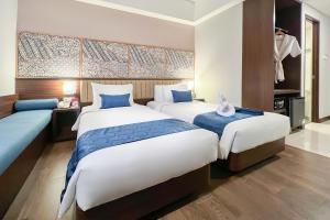 Een bed of bedden in een kamer bij @HOM Premiere Timoho
