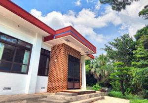 a house with a brick pillar on the front of it at Casa Yamamoto by Griswood Hotels in Ie
