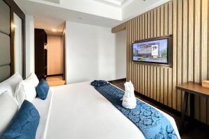 Een bed of bedden in een kamer bij @HOM Premiere Timoho