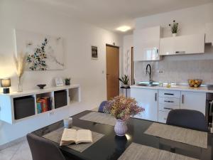 a kitchen with a table and a dining room at Del Mar Rabac in Rabac