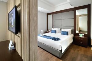 Een bed of bedden in een kamer bij @HOM Premiere Timoho