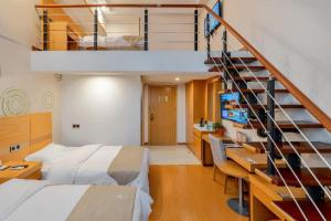 a bedroom with a bed and a staircase at GreenTree Inn Suzhou Changshu North Haiyu Road Changhui Square Express Hotel in Changshu