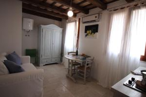 a living room with a white couch and a table at Il Borgo Trapanese in Trapani