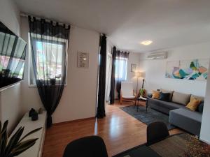 a living room with a couch and a table at Del Mar Rabac in Rabac