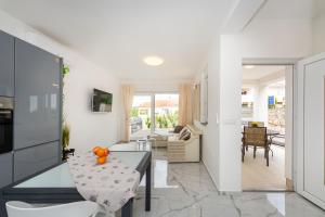 a kitchen and living room with a table and chairs at Three Seas in Maslenica