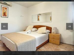 a bedroom with a bed with a mirror and a nightstand at Villa Apartments Babaja in Omiš +73 photos