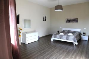 a bedroom with a bed and a dresser at Affittacamere Sogni D'oro in Lamezia Terme
