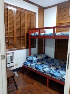 a bedroom with two bunk beds and a window at 3BR Condo up to 12pax at Palm Towers Makati in Manila +11 photos