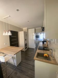 a kitchen with a sink and a counter top at AV ApartmenT in Rēzekne