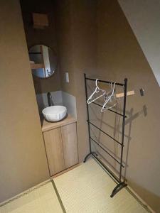 a bathroom with a sink and a mirror at Sakae Guesthouse in Nagoya
