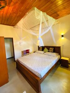 a bedroom with a bed with a net at The beach gate villa in Beruwala +36 photos