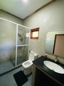a bathroom with a toilet and a sink and a shower at The beach gate villa in Beruwala