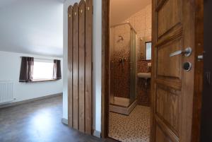 a bathroom with a shower and a wooden door at Ventspils Centra Apartamenti in Ventspils +101 photos