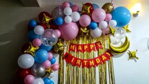 a bunch of balloons with a happy birthday sign at Raniban Lila's Homestays in Kathmandu