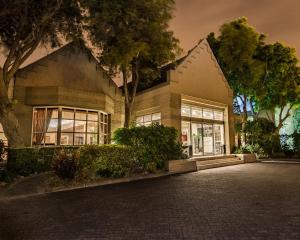 a house with a lot of windows on a street at City Lodge Hotel Pinelands in Cape Town