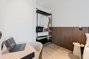 a living room with a laptop on a table at Appart Hotel Neostelia in Annecy
