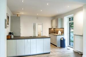 a kitchen with white cabinets and a counter top at Am Grasengrundsberg in Soltau
