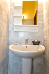 a bathroom with a sink and a mirror at Il Veliero Blu Suite Lipari Centro - Corso Vittorio Emanuele in Lipari