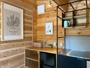 a kitchen with wooden walls and a wooden counter top at Naoshima Cottage in Naoshima