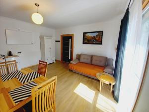 a living room with a couch and a table at Pod lasem Celina Burda in Majdan Sopocki
