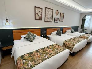 Letto o letti in una camera di Vishan Garden Boutique Hotel 厦门维尚花园潮宿 中山路步行街店