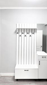 a white cabinet with birds on it in a kitchen at Cozy Almaty Escape in Almaty