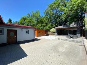 a large patio with a building and a garage at Villa Tomima in Ostrava