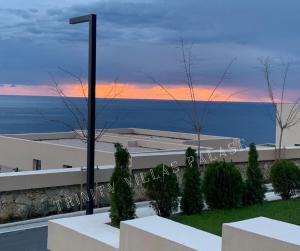 a view of the ocean at sunset from a building at Palase Green Coast 2 bedroom house in Himare