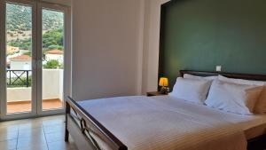 a bedroom with a bed and a large window at Villa Sol in Bali in Bali