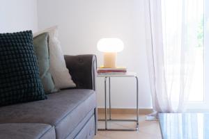 a lamp on a side table next to a couch at Villa Sol in Bali in Bali