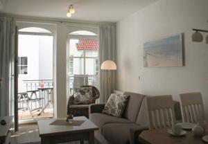 a living room with a couch and a table at Haus Meeresblick - Ferienwohnung Albatros (Ref. 152813) in Baabe