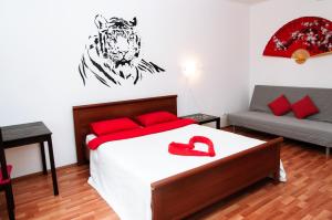 a bedroom with a bed with a tiger on the wall at Yin Yang in Moskva Complex in Yekaterinburg