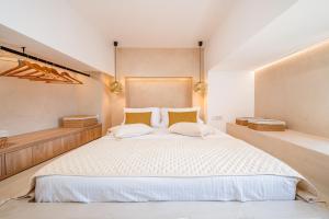 a bedroom with a large white bed with two pillows at Agartha-Infinite Sunset & Sea View in Asfendioú