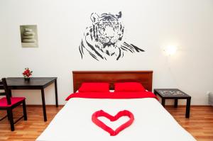 a bedroom with a bed with a tiger on the wall at Yin Yang in Moskva Complex in Yekaterinburg