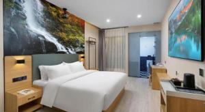 TV a/nebo společenská místnost v ubytování Sheng Lin Na Hotel Minzhi Branch
