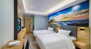 Postel nebo postele na pokoji v ubytování Sheng Lin Na Hotel Minzhi Branch