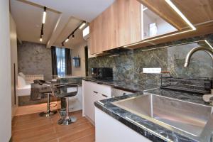 a kitchen with a sink and a counter top at Avenue Apart Hotel in Yerevan