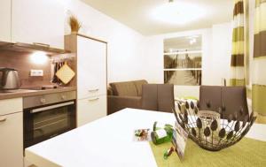 a kitchen with a table and a dining room at Haus Meeresblick - Ferienwohnung Am Strand (Ref. 128682u1) in Baabe