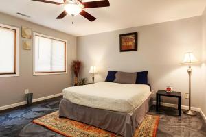 a bedroom with a bed and a ceiling fan at Fiddler on the Ridge-Woods, Wine and Wellness in Murphysboro