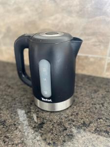 a black coffee pot sitting on a counter at Lakefront Luxury Retreat Munyonyo in Kampala