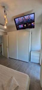 a living room with a flat screen tv on the wall at Suite Rivabella Rimini in Rimini